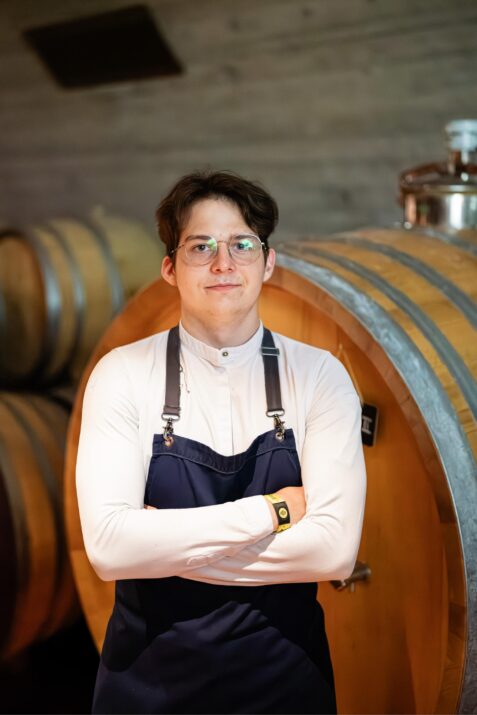 Muž v pivnici s sudmi.