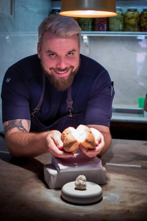 Kuchár prezentuje jedlo na tanieri.